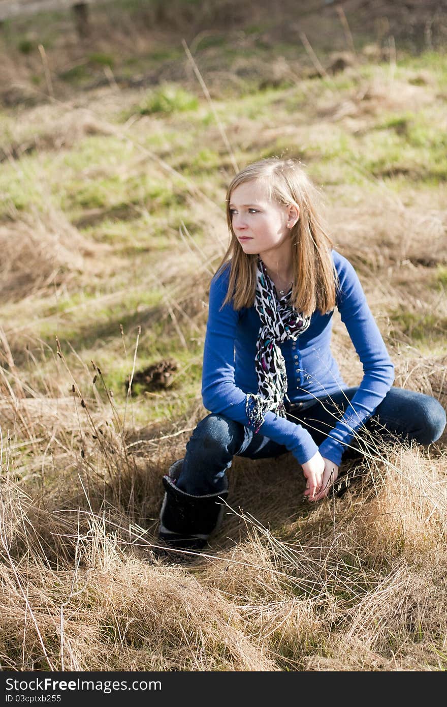 Beautiful young girl in a field of grass,. Beautiful young girl in a field of grass,