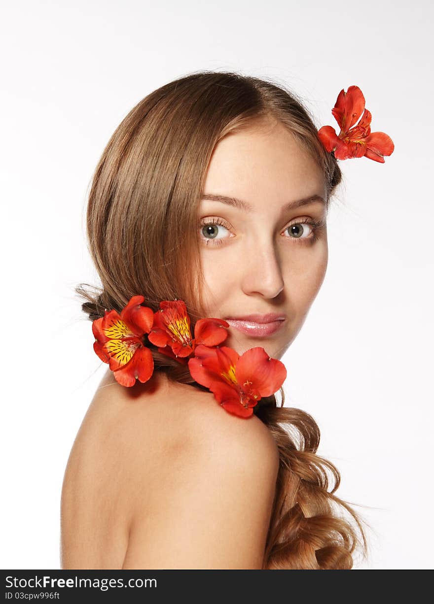 Portrait of the beauty young blond girl with lily in her hair