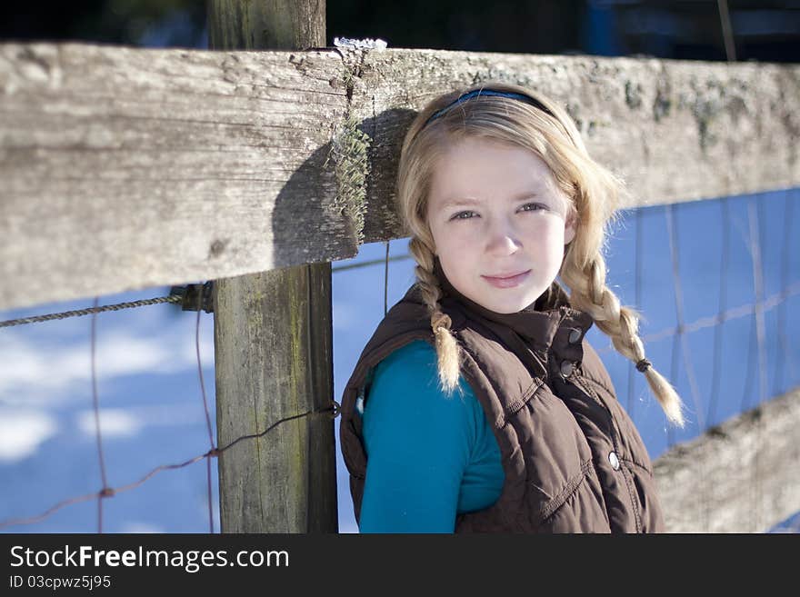 Young girl posing for the camera in a field of snow. Young girl posing for the camera in a field of snow