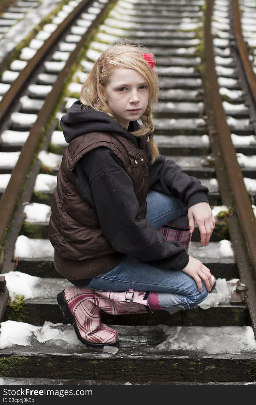 Young girl posing for the camera in a field of snow. Young girl posing for the camera in a field of snow