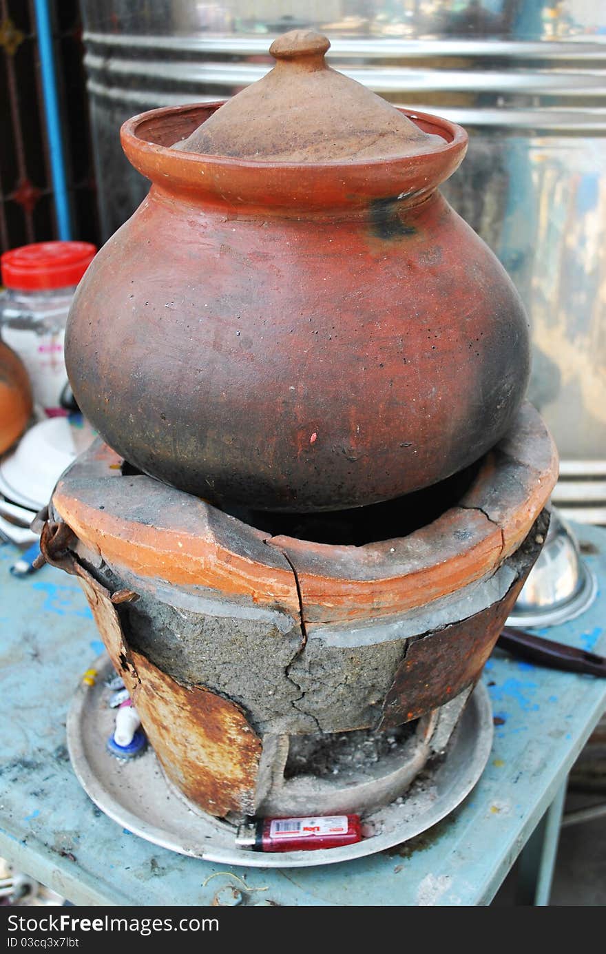 The pottery is on the charcoal burner. The pottery is on the charcoal burner