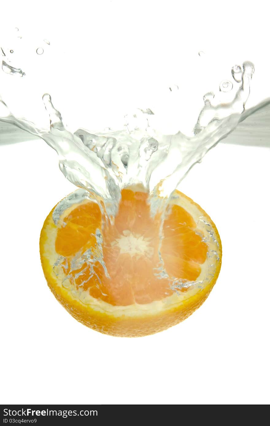 Orange thrown into the water with splash, on white background.
