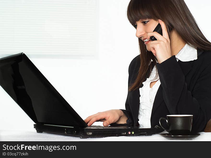 Nice girl in a business suit working in the office. Nice girl in a business suit working in the office