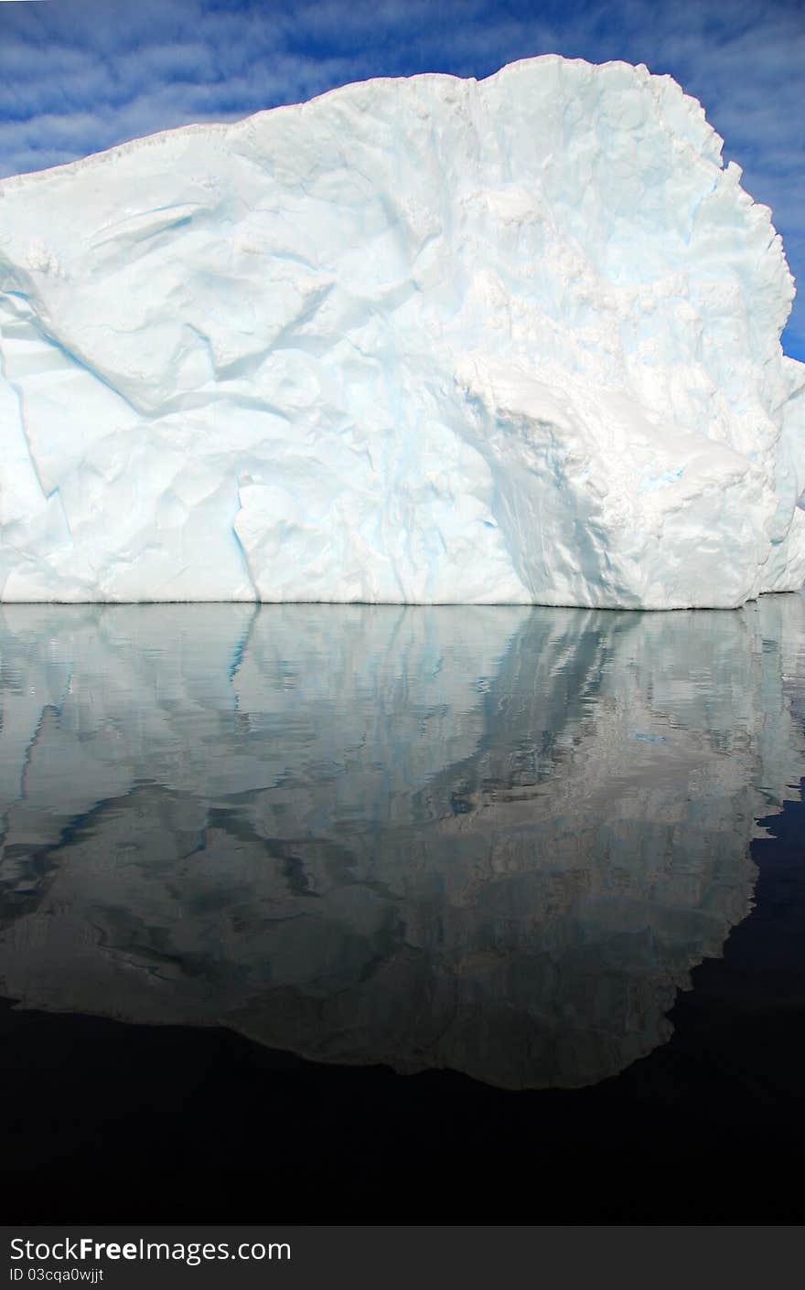 Iceberg perfectly reflected in the sea