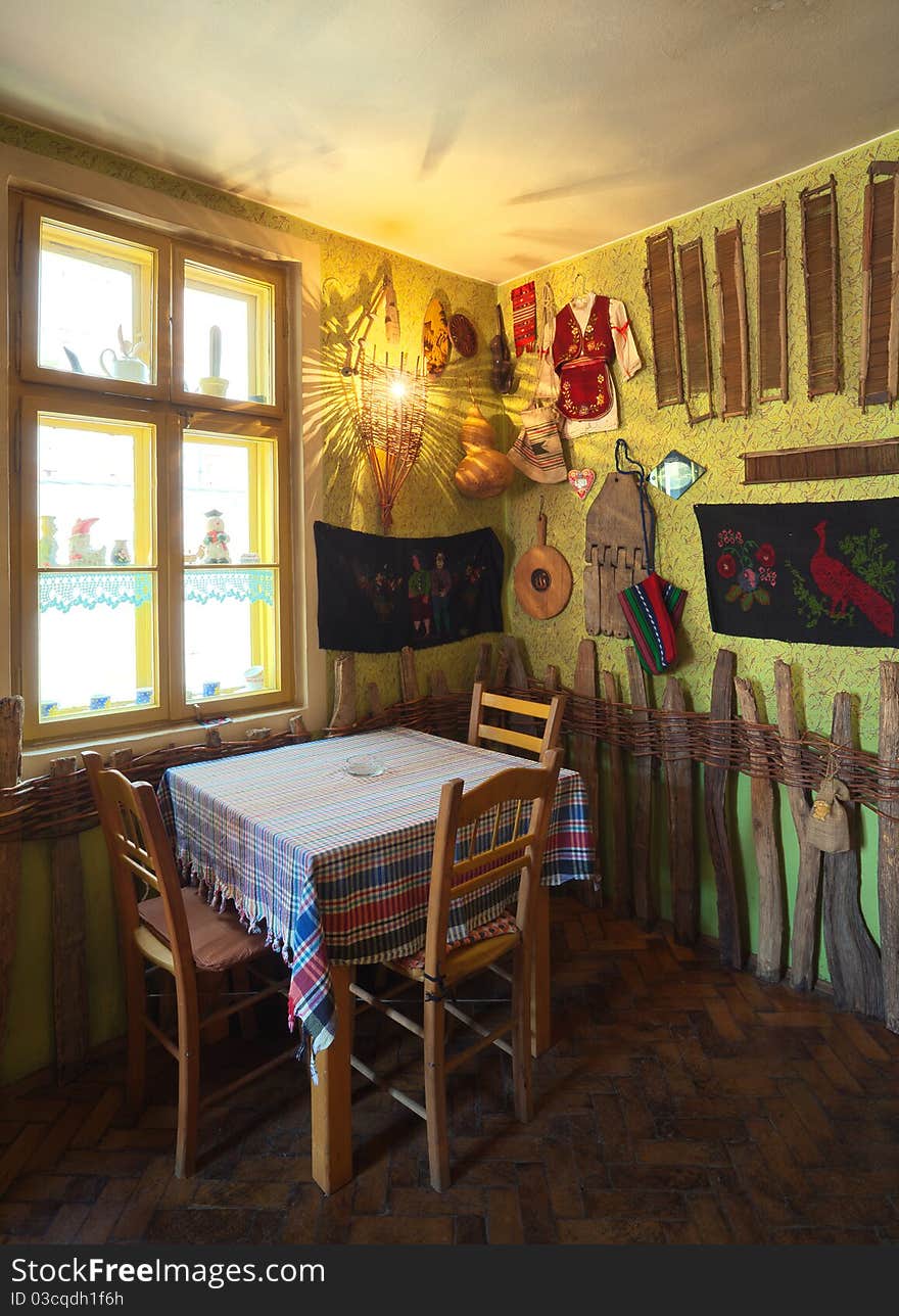 Interior of an old tavern, traditional Serbian style, souvenirs and old wooden furniture. Interior of an old tavern, traditional Serbian style, souvenirs and old wooden furniture.