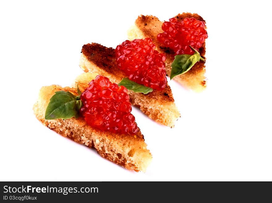 A photo of canapés with caviar and basil, in a form of heart. A photo of canapés with caviar and basil, in a form of heart.