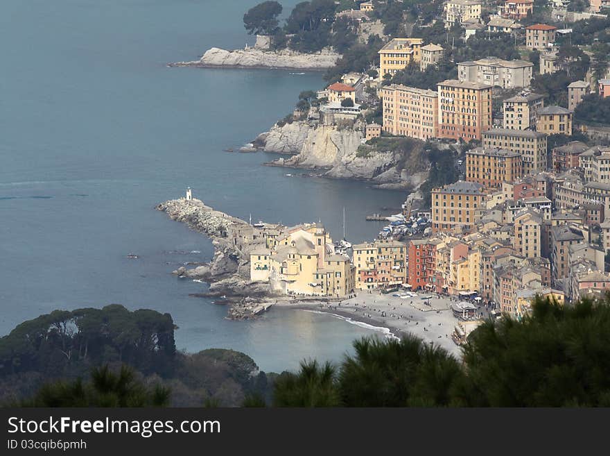 View of the city of mare from a point of view of a tree, you notice the seafront and the church. the bottom of the photo there is a branch of a tree. View of the city of mare from a point of view of a tree, you notice the seafront and the church. the bottom of the photo there is a branch of a tree