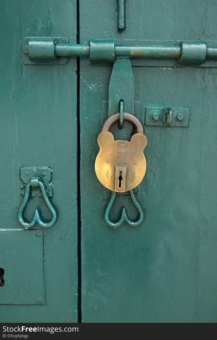 A mickey mouse shape lock on the green doors. A mickey mouse shape lock on the green doors