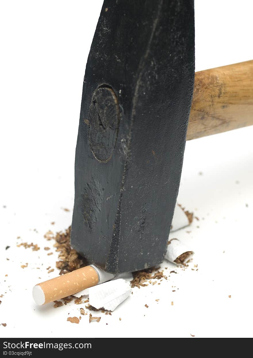 Cigarette smashed with hammer on white