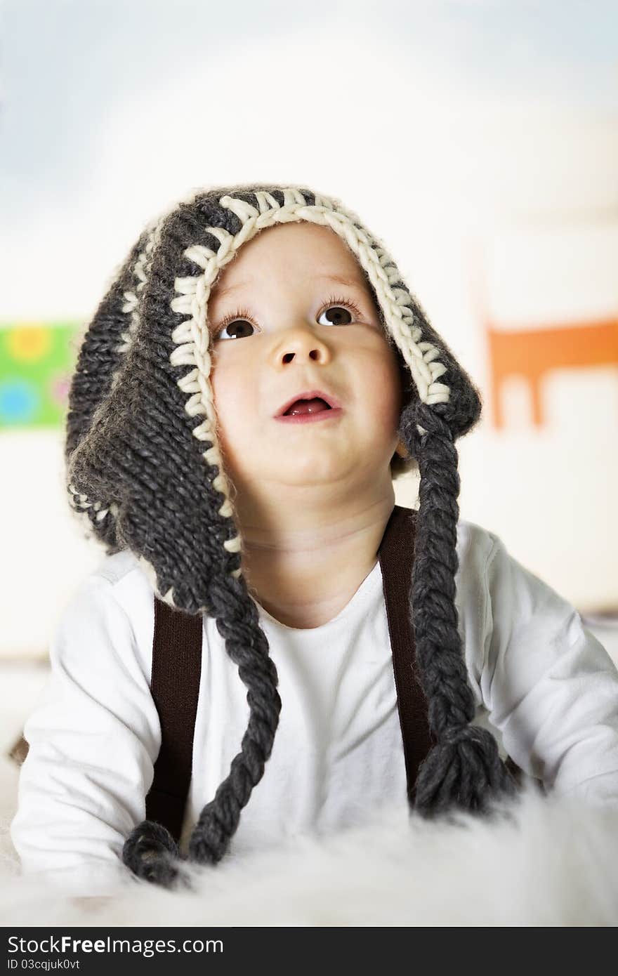 Baby Boy With Grey Cap Looking Up.