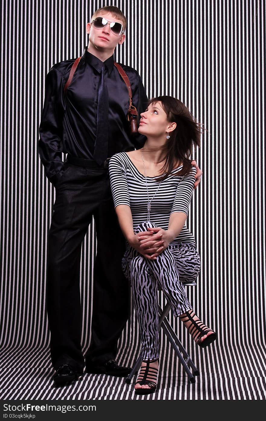 Young beautiful couple over stripe background. Young beautiful couple over stripe background