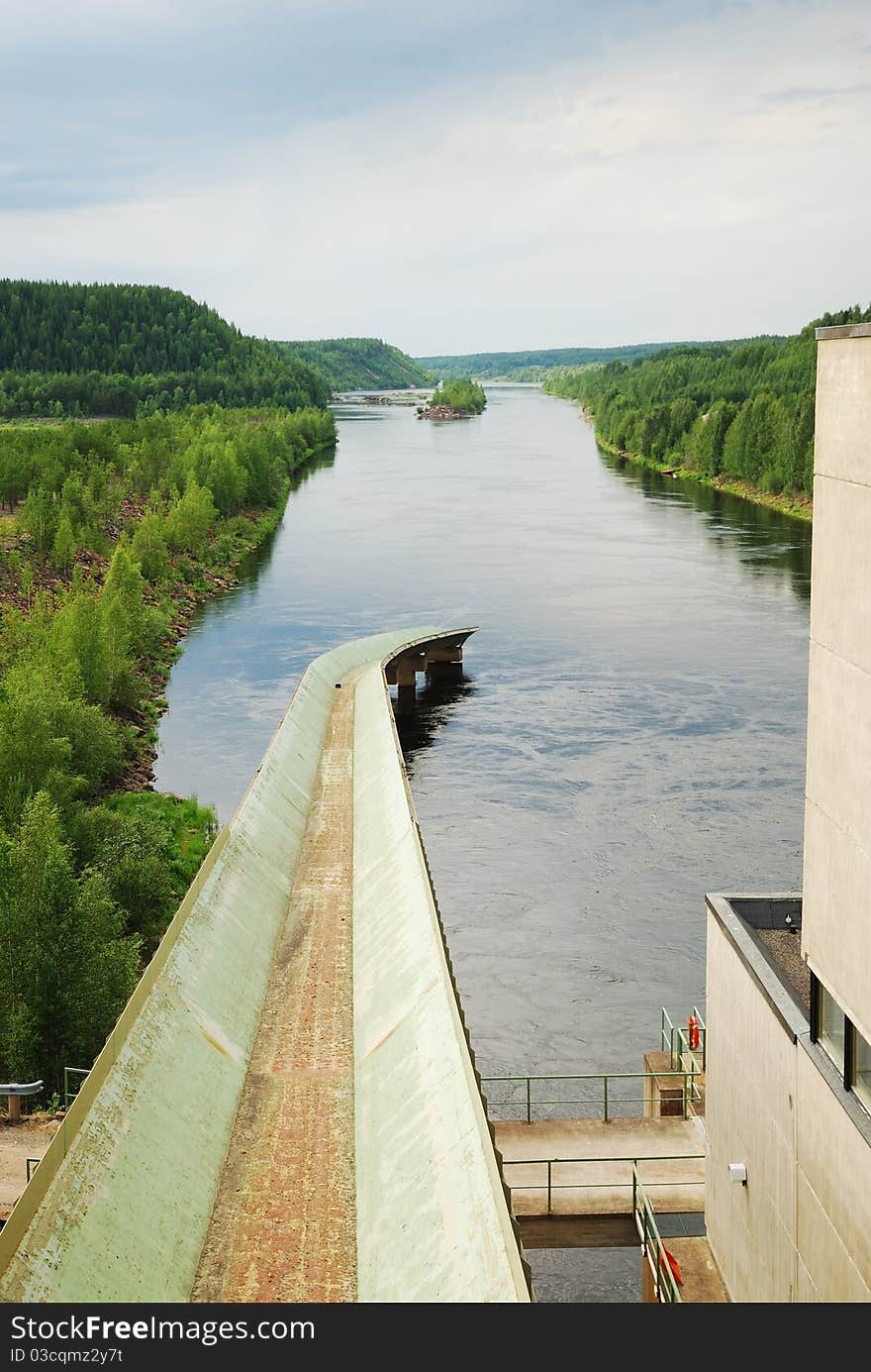 River with hydro power plant in taiga