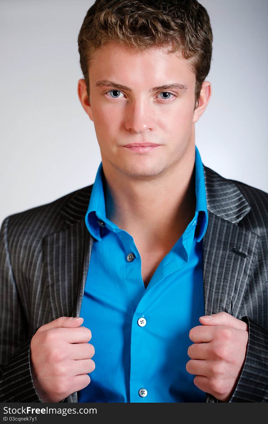 Young man poses wearing jacket and button shirt. Young man poses wearing jacket and button shirt.