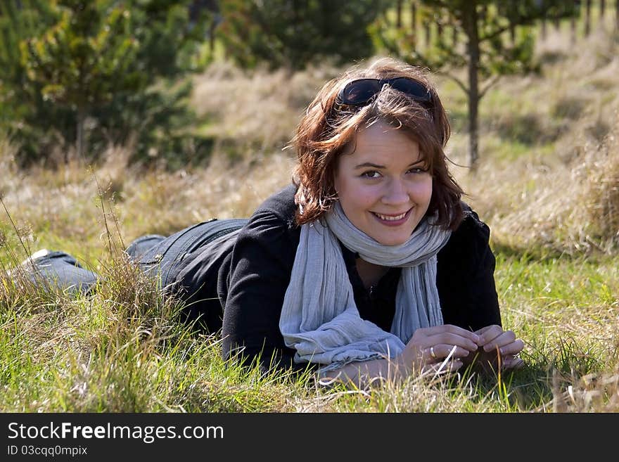 Image of a young woman laying on grass. Image of a young woman laying on grass