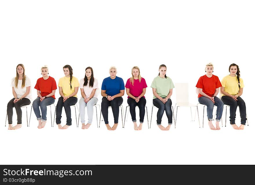 Group of women sitting on chairs and one empty chair. Group of women sitting on chairs and one empty chair