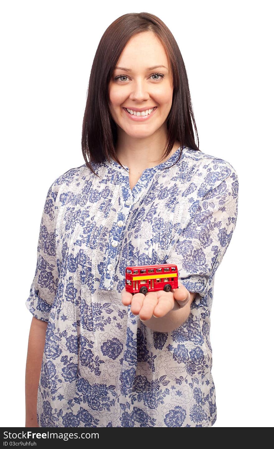 Young pretty woman with a british double deck bus on her hand on white background. Young pretty woman with a british double deck bus on her hand on white background