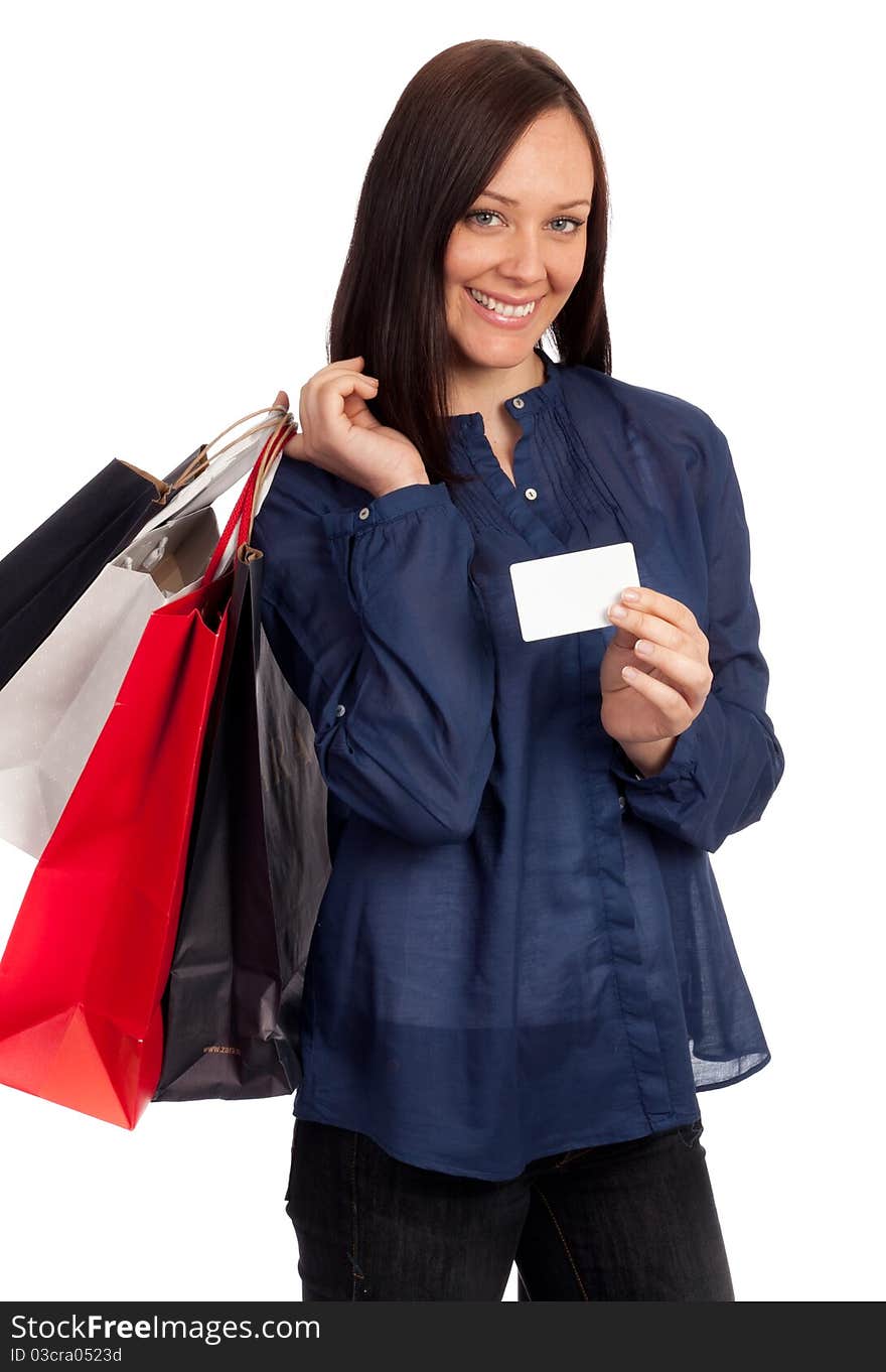 Pretty woman holding shopping bags and credit card on white background