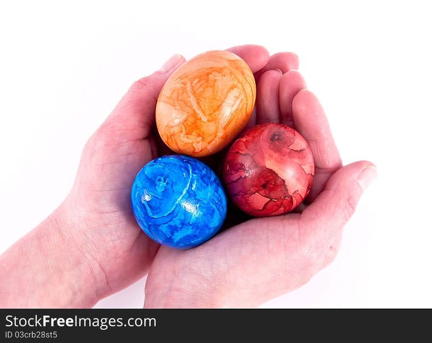 Girls hands holding painted eggs.