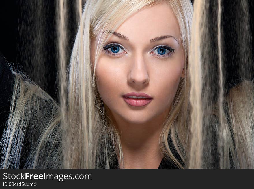 Close-up portrait of a young woman with magnificent hair and sand. Close-up portrait of a young woman with magnificent hair and sand