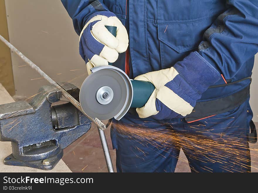 A man working with grinder, close up on tool, hands and sparks, real situation picture. A man working with grinder, close up on tool, hands and sparks, real situation picture