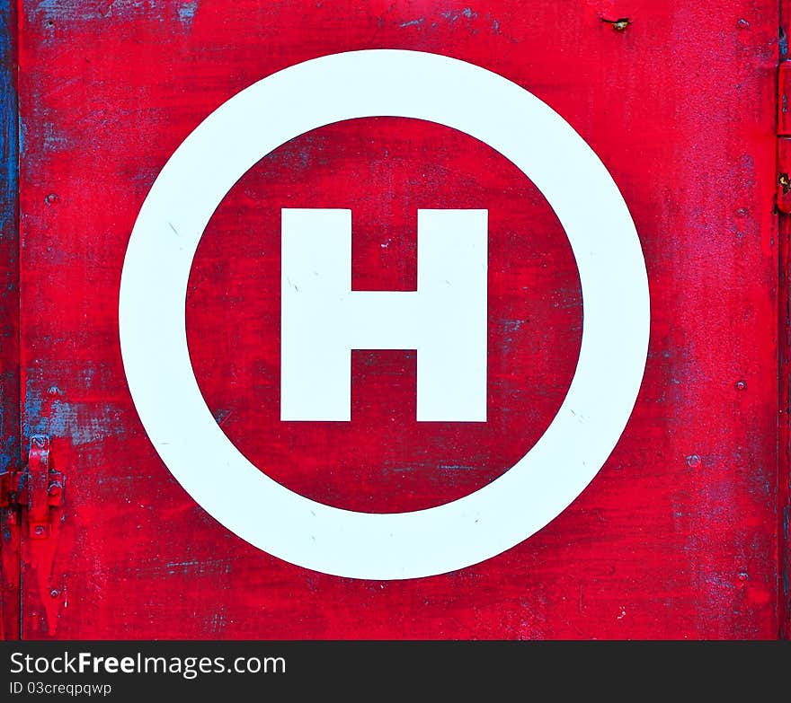 Red grunge background and white H as symbol for hydrant. Red grunge background and white H as symbol for hydrant