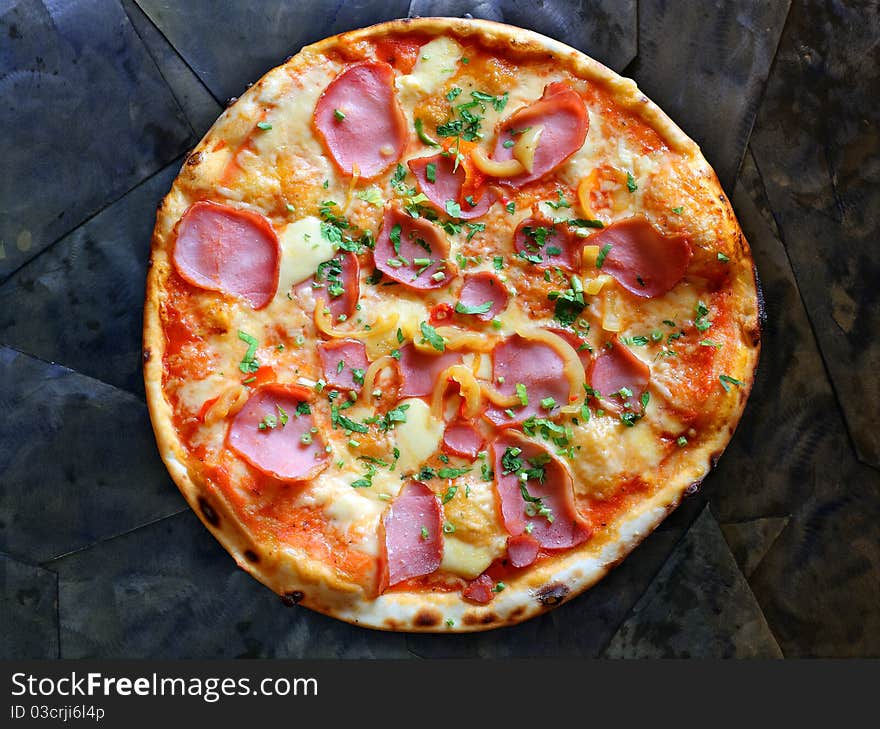 Appetizing pizza with bacon and pepper on stone