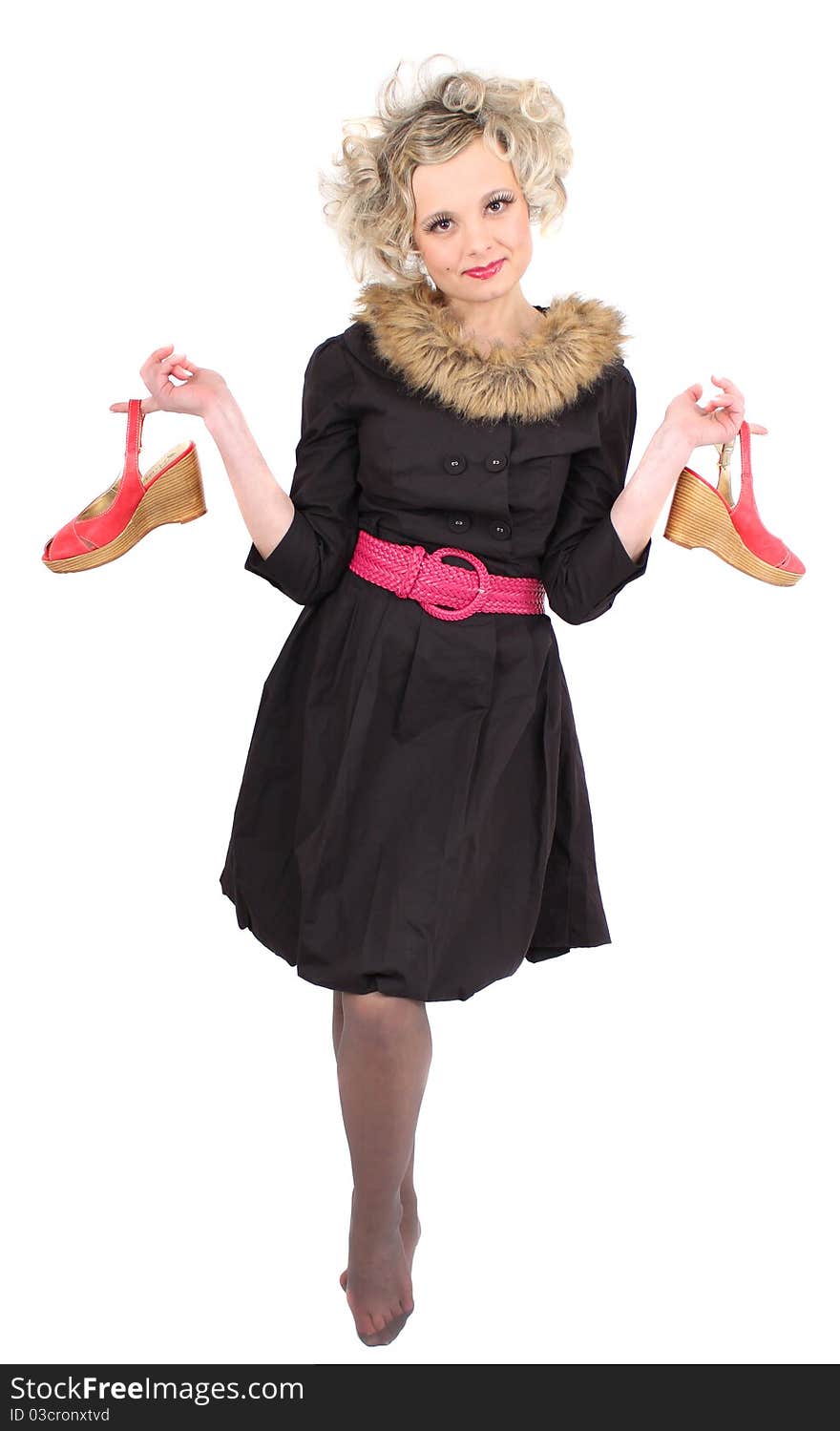 Woman in black dress holding red shoes. Woman in black dress holding red shoes