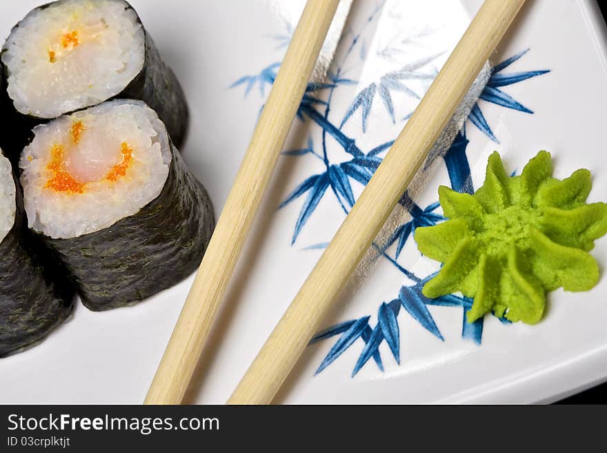 Sushi - Roll made of Smoked Eel, Cream Cheese and Deep Fried Vegetables inside. Fresh Salmon outside. Sushi on the plate