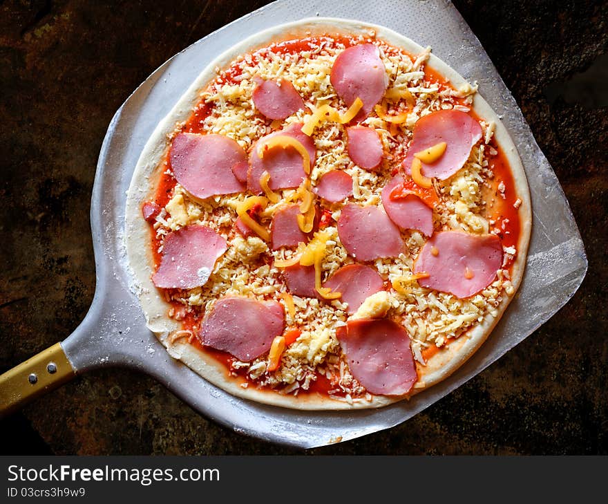 Appetizing pizza with bacon and pepper on a wooden tray