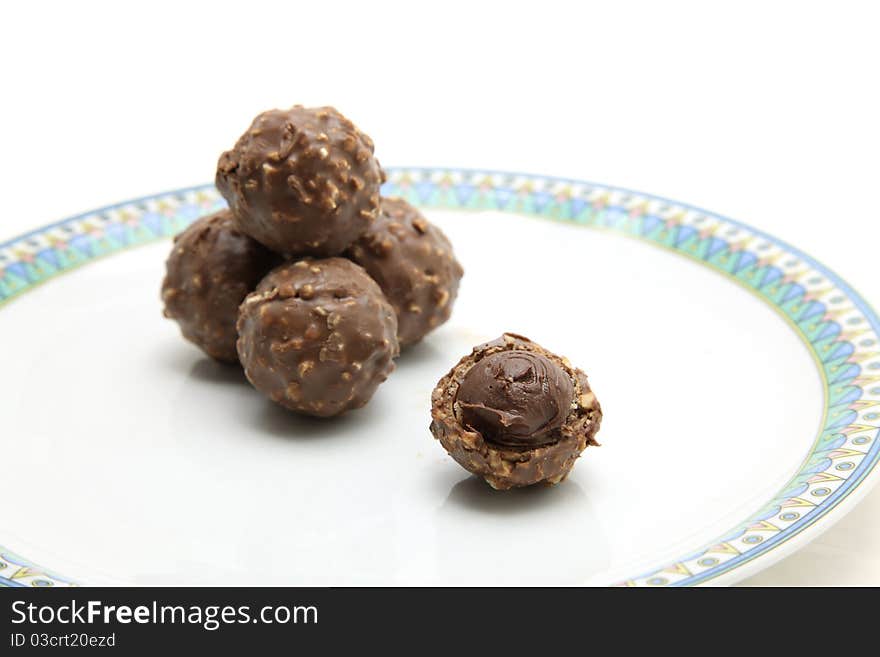 Perspective of chocolate candy on white dish