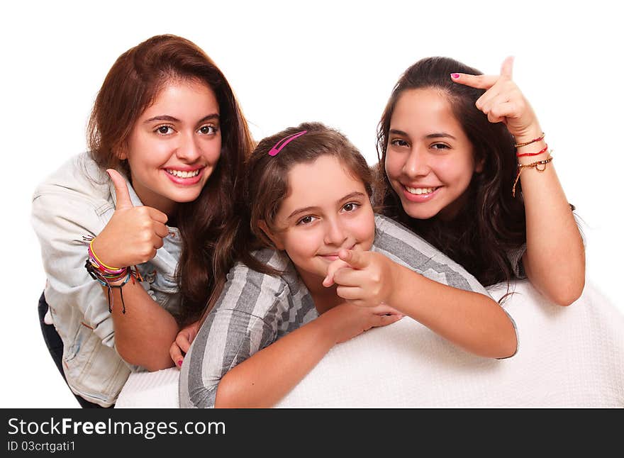 Three beautiful teenagers pointing their hands to different places