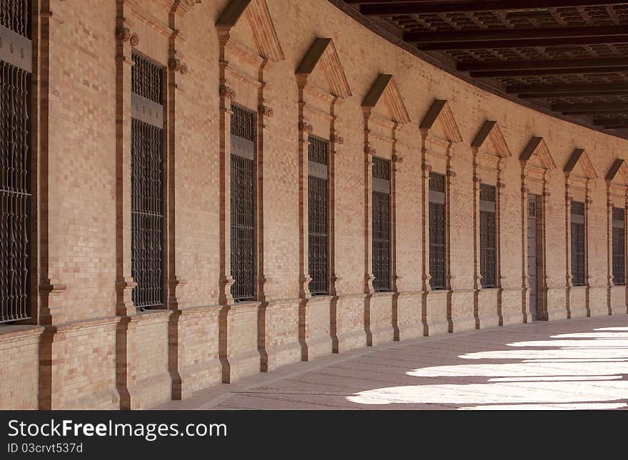 Curved brick facade perspective in historical building in Sevilla. Curved brick facade perspective in historical building in Sevilla