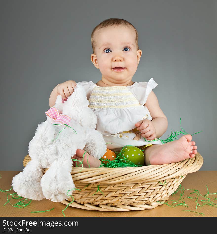 Young babay girl sitting and playing with easter egg. Very cute baby. Young babay girl sitting and playing with easter egg. Very cute baby.