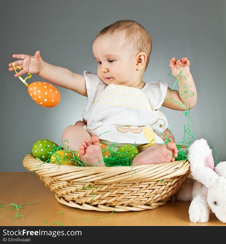 Young babay girl sitting and playing with easter egg. Very cute baby. Young babay girl sitting and playing with easter egg. Very cute baby.