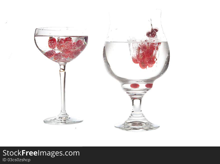 Falling red-berries in a bowl of sparkling water. Falling red-berries in a bowl of sparkling water