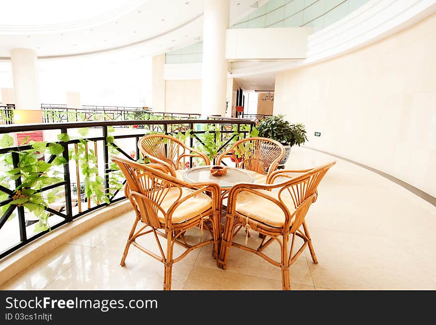 The hotel lobby lies the wicker chair. The hotel lobby lies the wicker chair