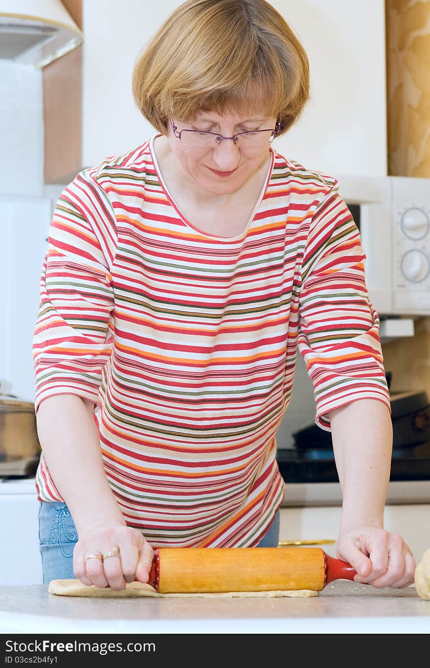 The Aged Woman Unrolls Dough