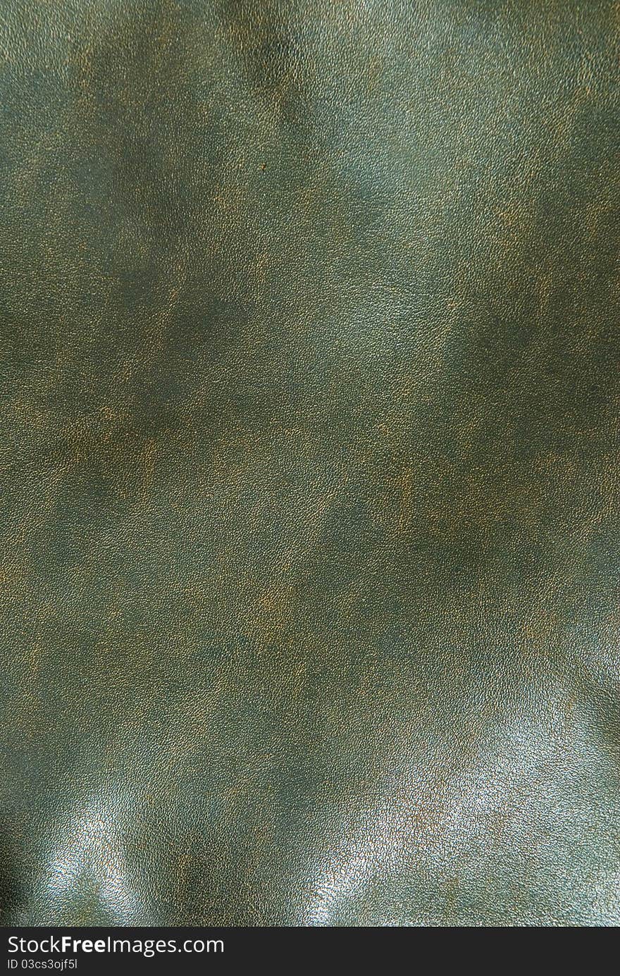 Iny brown leather background close up. Iny brown leather background close up