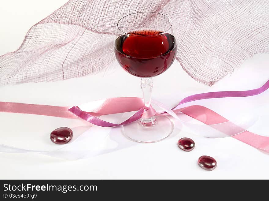 Glass of red wine with ribbons and decorations. Glass of red wine with ribbons and decorations