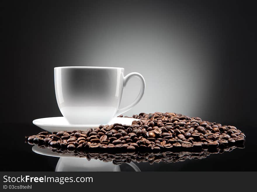 White Cup With Coffee Beans On Black