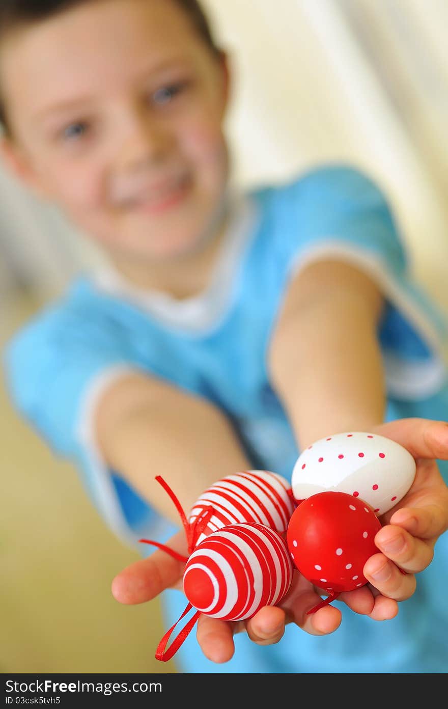 Easter kid with colorful eggs with focus on eggs