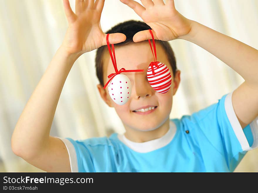 Boy playing with Easter eggs with focus on eggs