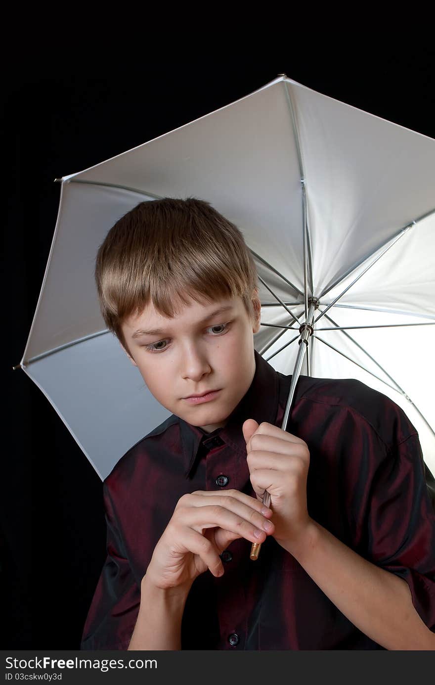 Portrait of a young man. In his hands he held a white umbrella.