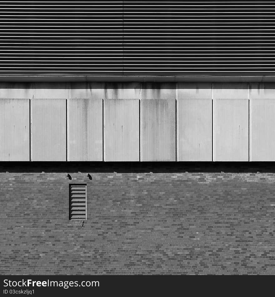 An element (part of the wall) of a modern industrial building, with strong shadows emphasizing the textures. An element (part of the wall) of a modern industrial building, with strong shadows emphasizing the textures.