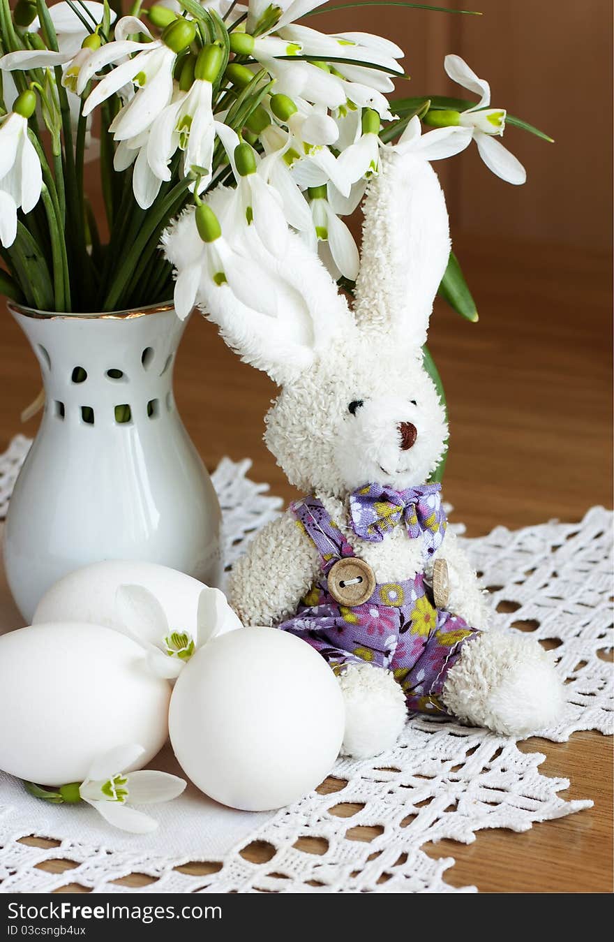 Eggs,toy rabbit and snowdrops