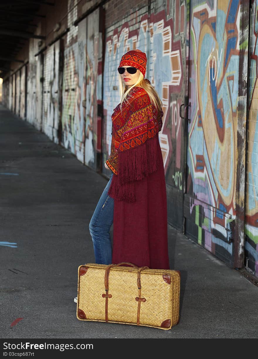 Woman with an old fashioned suitcase Waiting on a very old railroad station platform