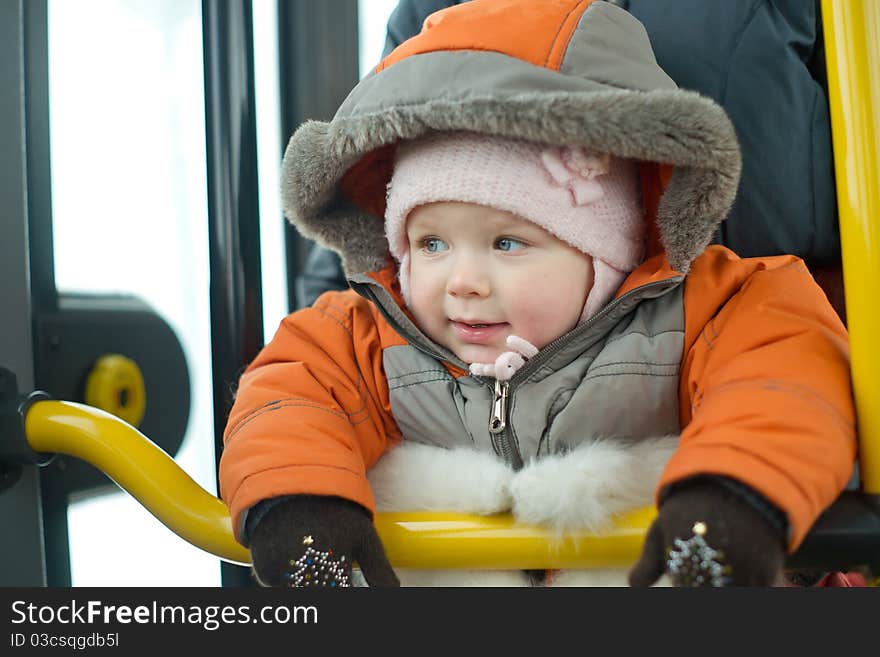 Mother with young baby stay near bus doors preparing to exit from bus