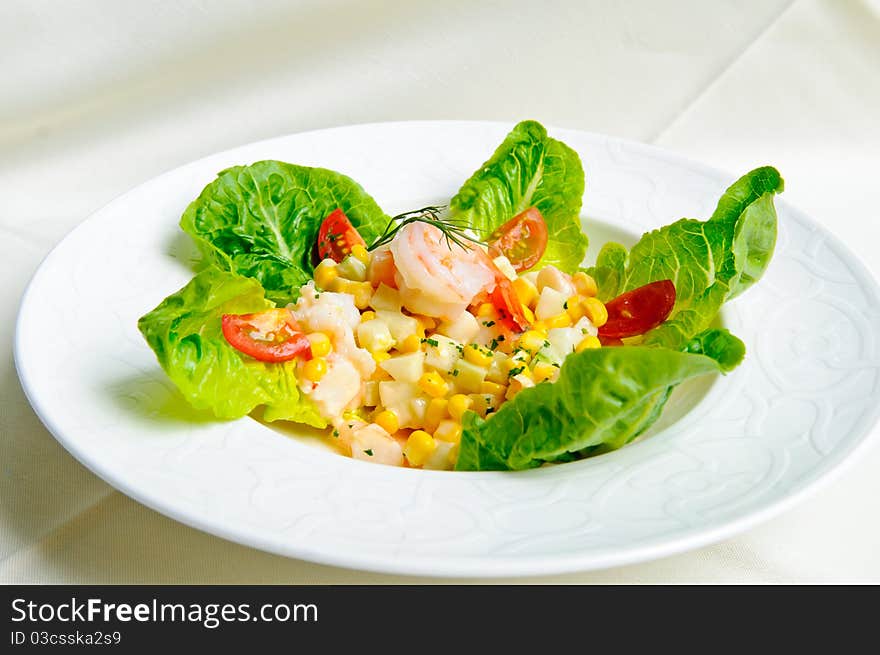 Tasty green salad with prawns and corn