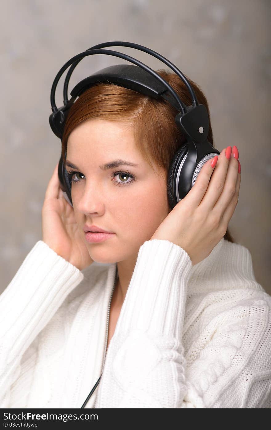 Beautiful young girl listens to her favorite tunes. Beautiful young girl listens to her favorite tunes