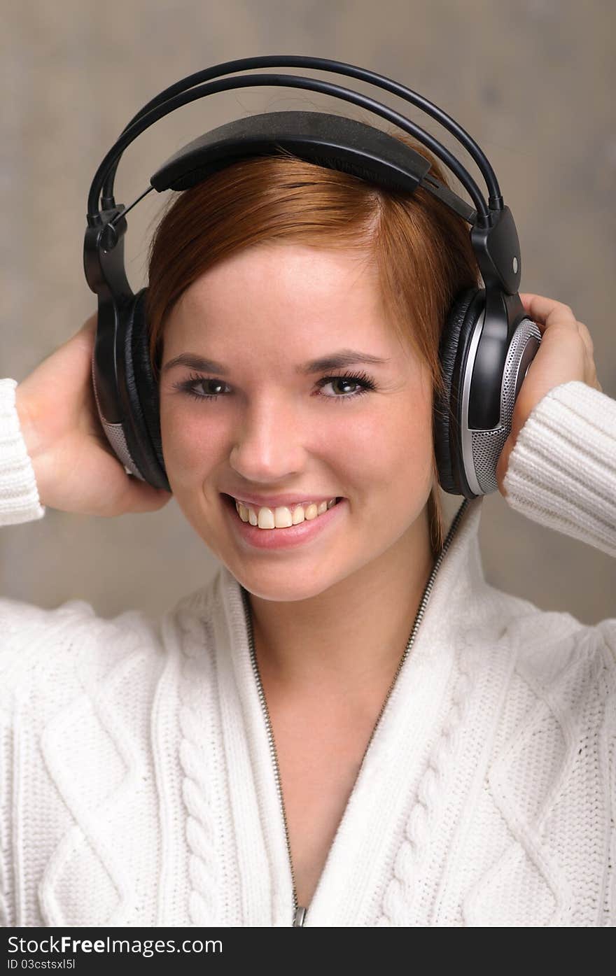 Beautiful young girl listens to her favorite tunes. Beautiful young girl listens to her favorite tunes